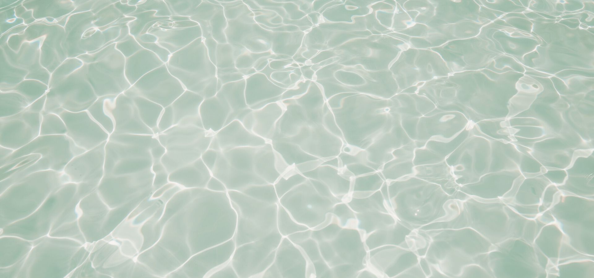 Sunlit turquoise water with rippling caustic light