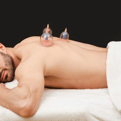 Cupping therapy: glass cups placed across a man's upper back